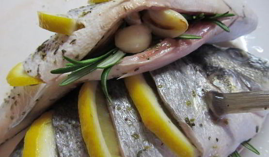 дорада, запеченная с лимоном, чесноком и травами